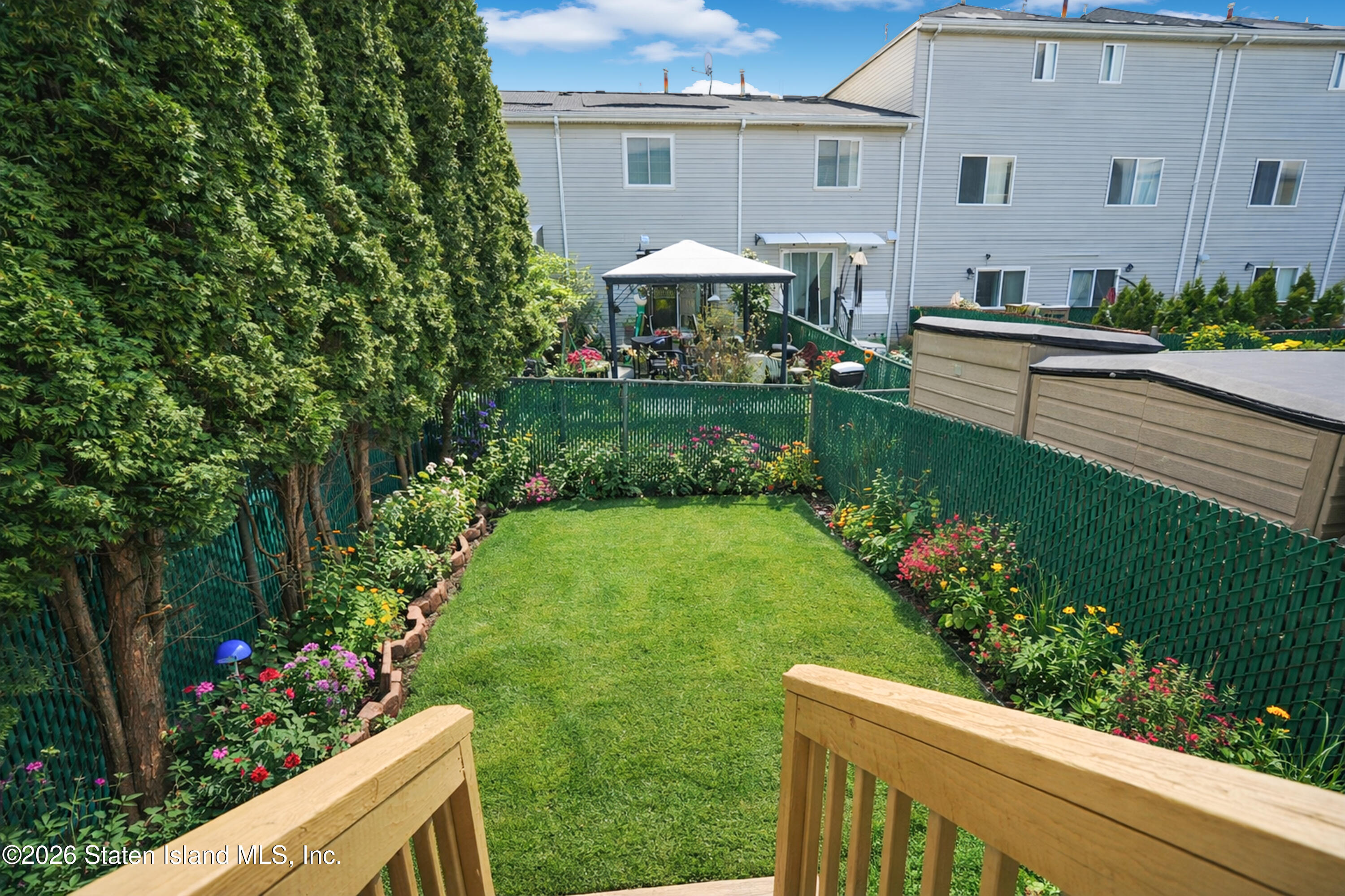 48 Studio Lane Staten Island, NY 10304 - Photo 17 of 38 a front view of a house with a yard and fountain