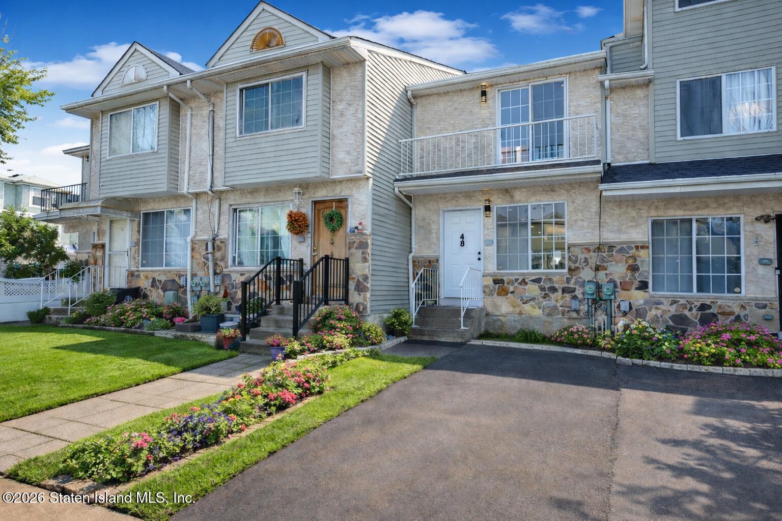 48 Studio Lane Staten Island, NY 10304 - Photo 2 of 38 a front view of a house with garden