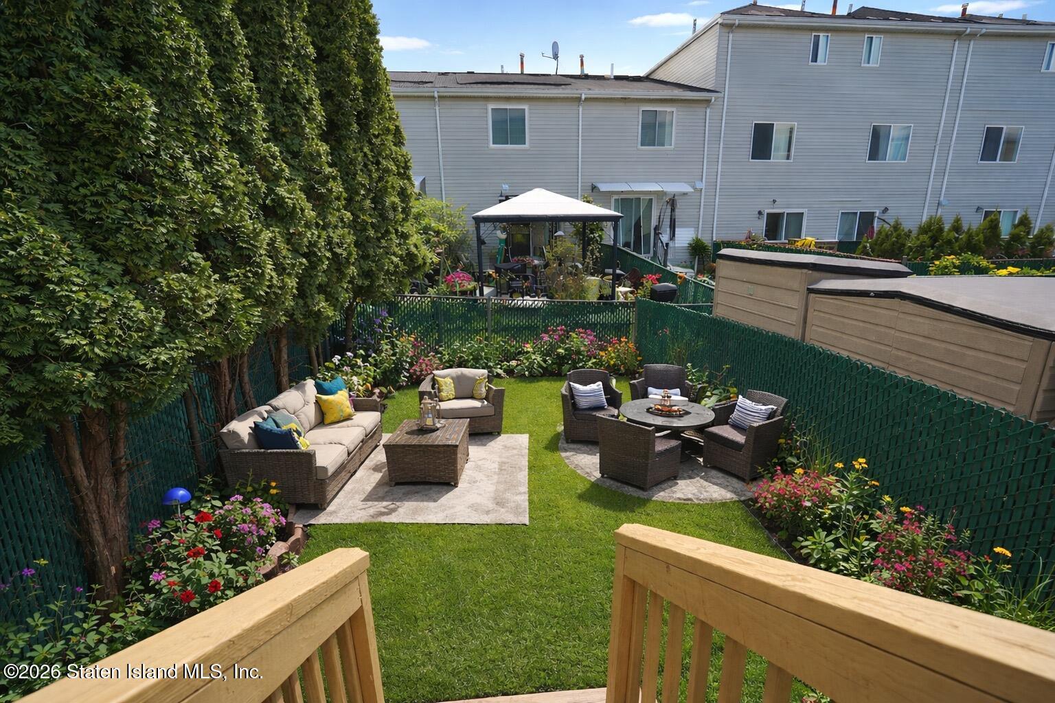 48 Studio Lane Staten Island, NY 10304 - Photo 32 of 38 a front view of a house with a garden and plants