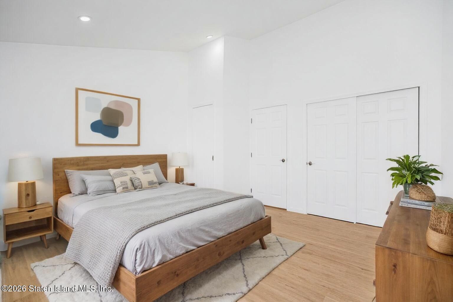 48 Studio Lane Staten Island, NY 10304 - Photo 34 of 38 a bedroom with a bed and a potted plant