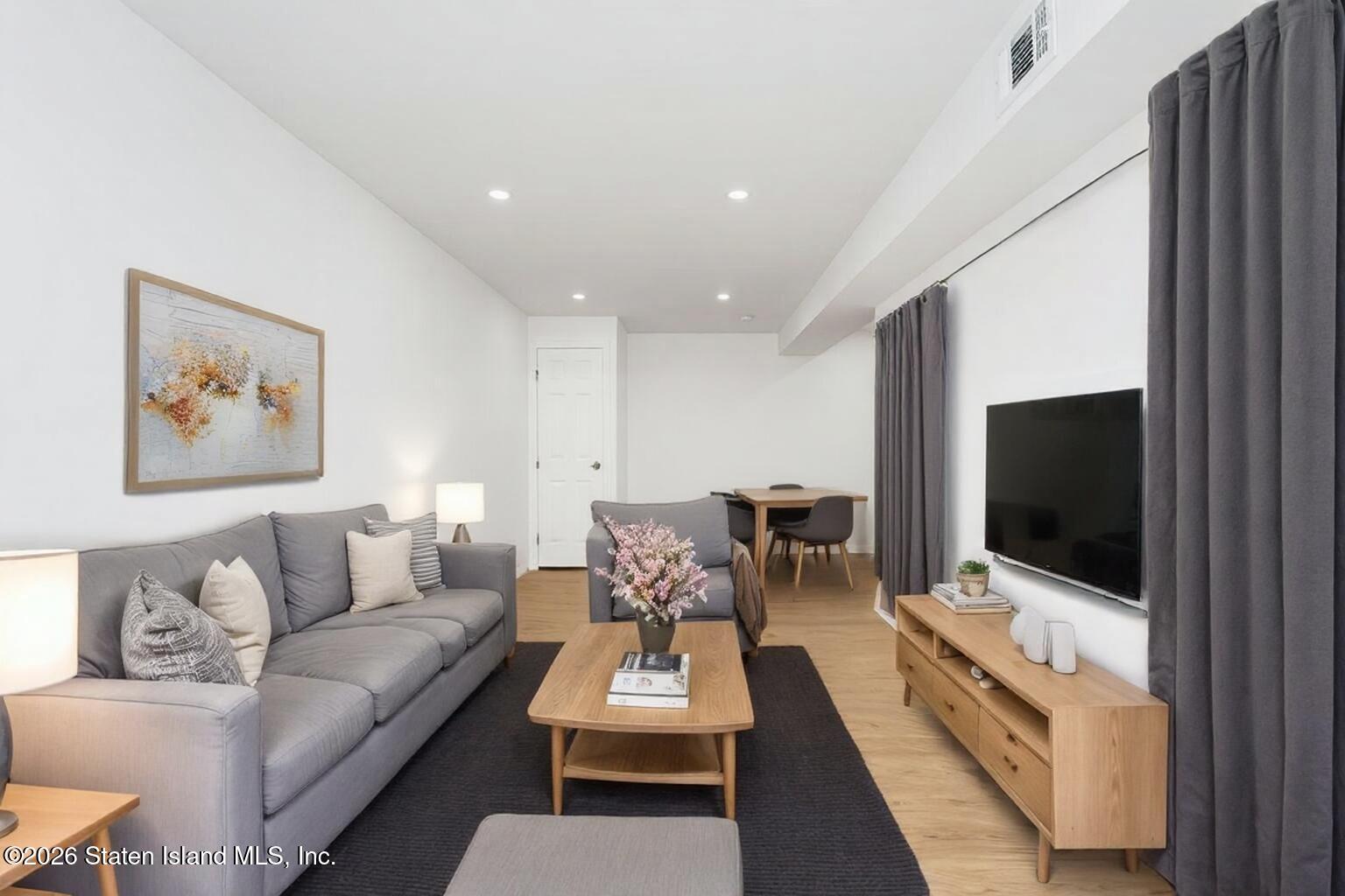 48 Studio Lane Staten Island, NY 10304 - Photo 36 of 38 a living room with furniture and a flat screen tv