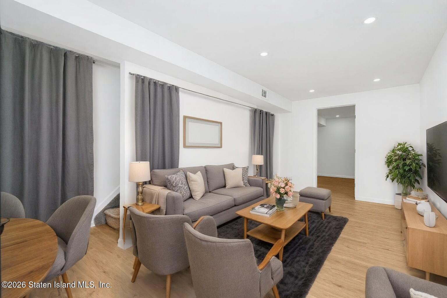 48 Studio Lane Staten Island, NY 10304 - Photo 37 of 38 a living room with furniture and wooden floor