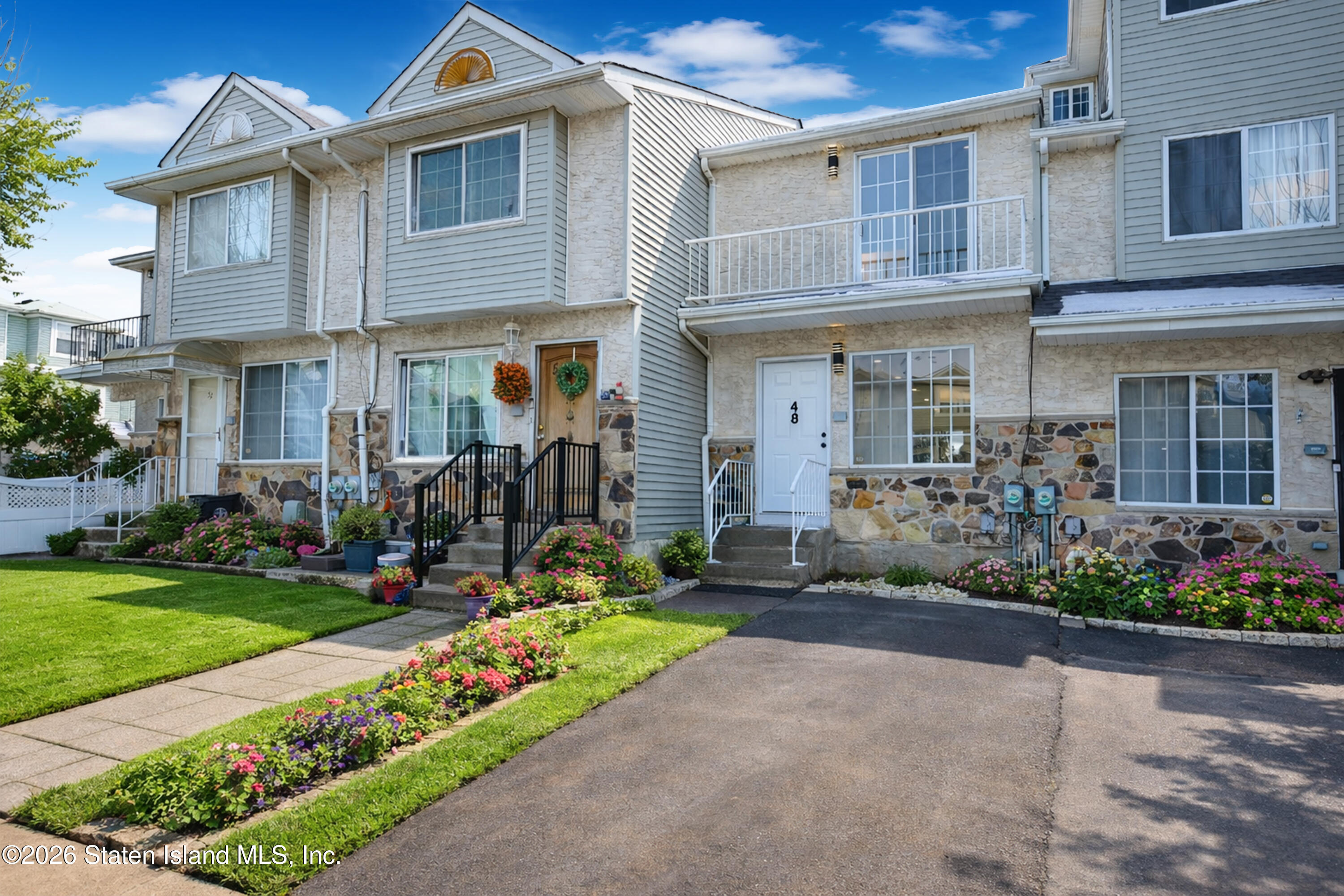 48 Studio Lane Staten Island, NY 10304 - Photo 4 of 38 a front view of a house with garden