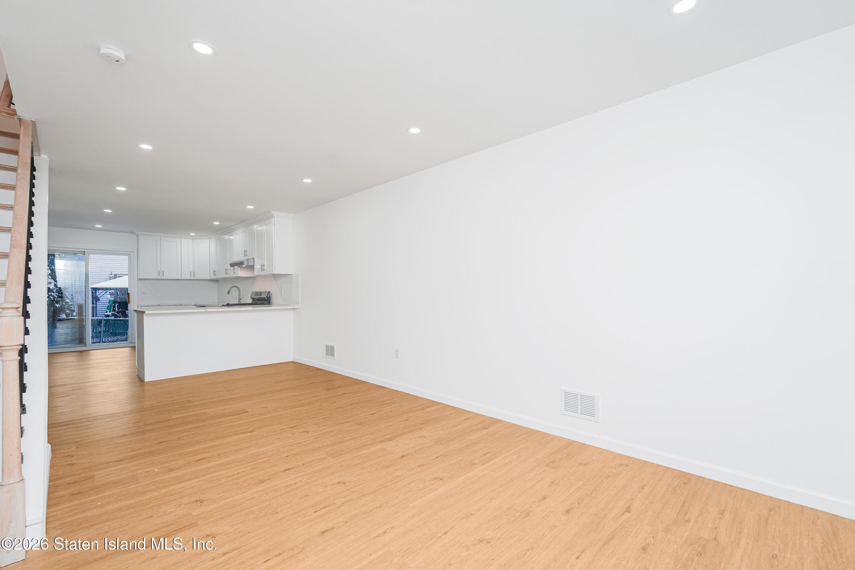 48 Studio Lane Staten Island, NY 10304 - Photo 5 of 38 a view of kitchen with kitchen island white cabinets and wooden floor