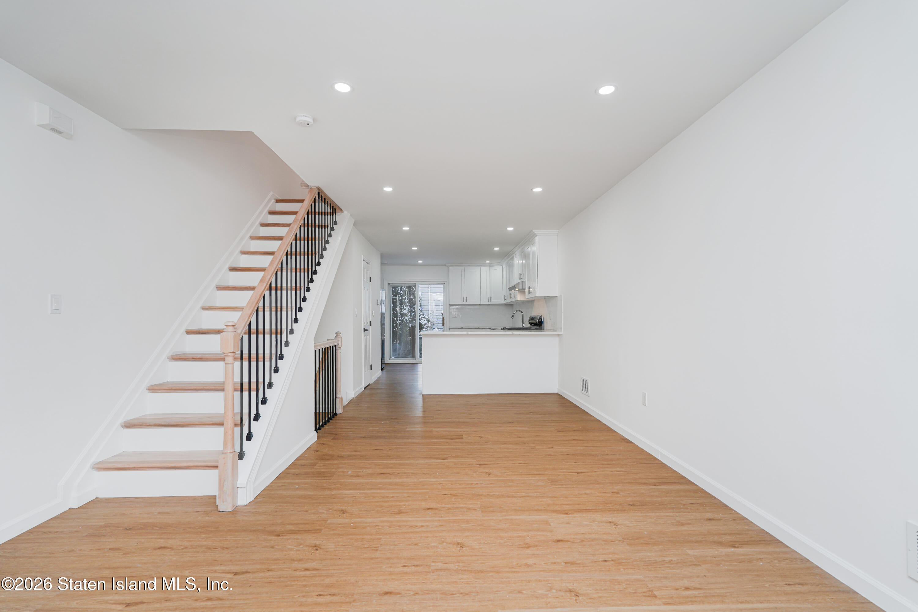 48 Studio Lane Staten Island, NY 10304 - Photo 6 of 38 a view of a kitchen with wooden floor and stairs