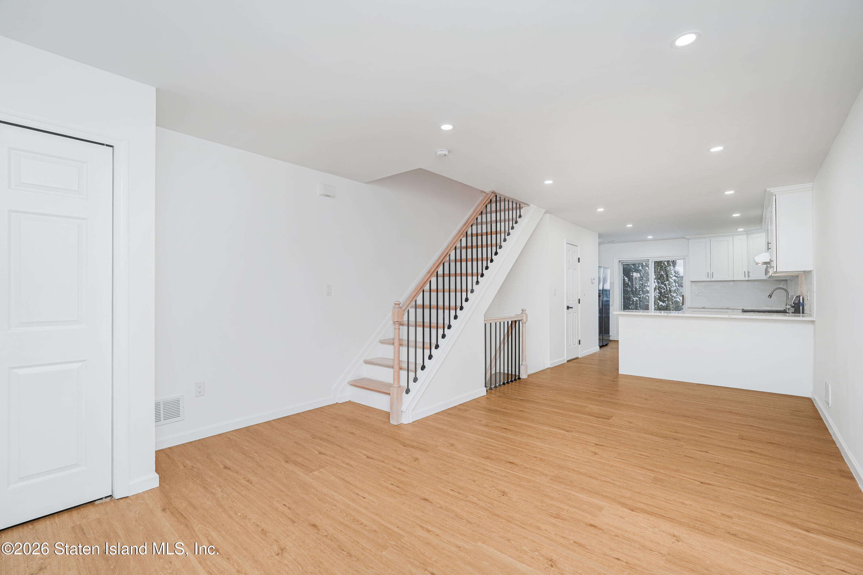 48 Studio Lane Staten Island, NY 10304 - Photo 7 of 38 a view of an empty room with wooden floor and stairs