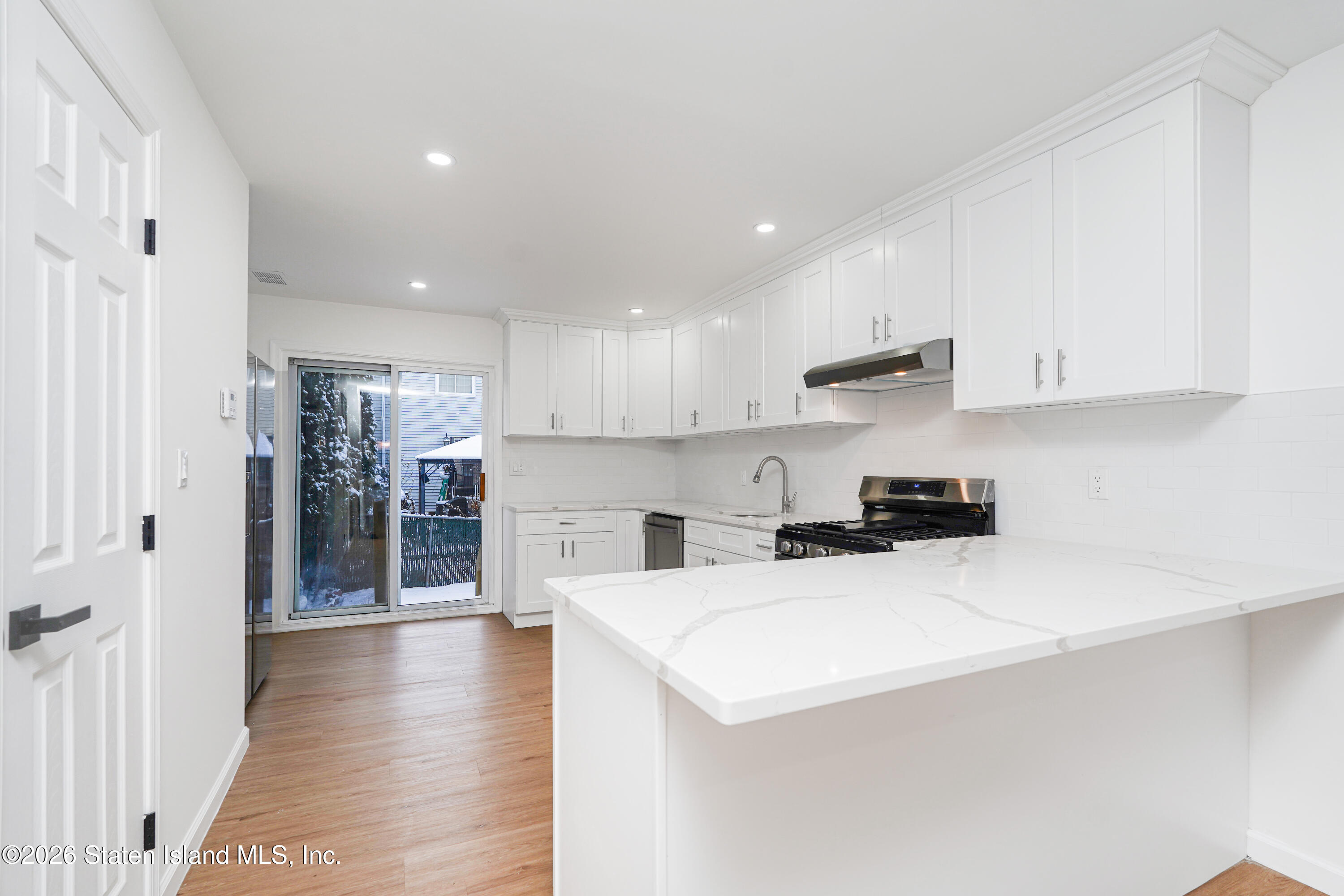 48 Studio Lane Staten Island, NY 10304 - Photo 9 of 38 a kitchen with stainless steel appliances a refrigerator sink and cabinets