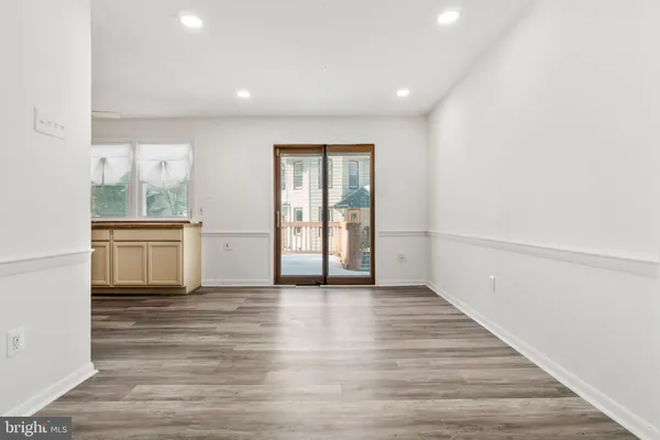 a view of a kitchen with wooden floor and electronic appliances