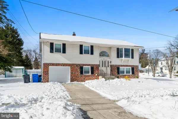 a view of a house with snow on the background