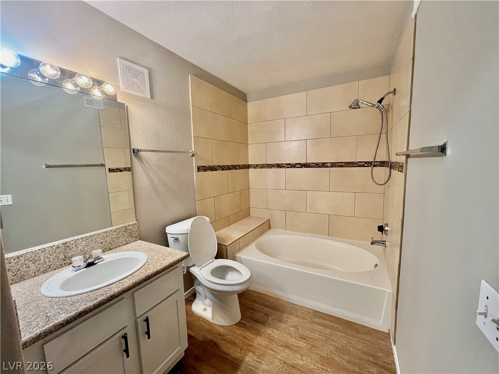 7885 West Flamingo Road, Unit 1029 Las Vegas, NV 89147 - Photo 16 of 18 A well-appointed bathroom features a bathtub, toilet, and vanity with ample storage.