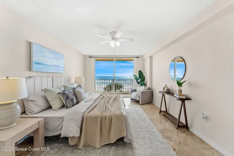 a bedroom with bed and a chandelier