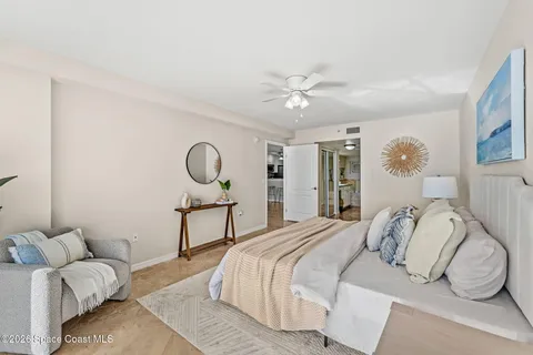a bedroom with a bed ceiling fan and a window