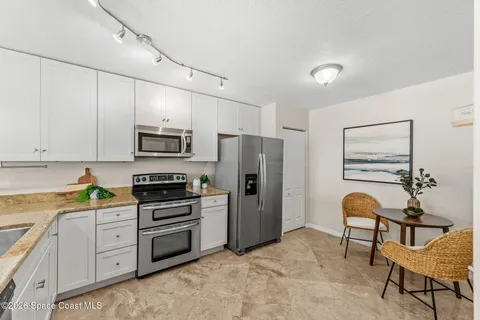 a kitchen with stainless steel appliances a stove refrigerator sink and cabinets