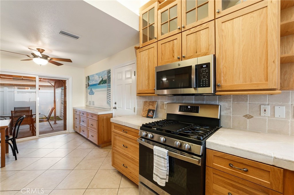 31760 Corte Tortosa Temecula, CA 92592 - Photo 9 of 46 a kitchen with stainless steel appliances granite countertop a stove a sink and a microwave