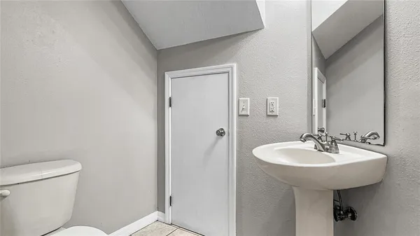 a bathroom with a sink toilet and a mirror