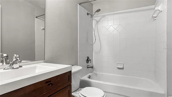 a bathroom with a sink toilet tub and shower