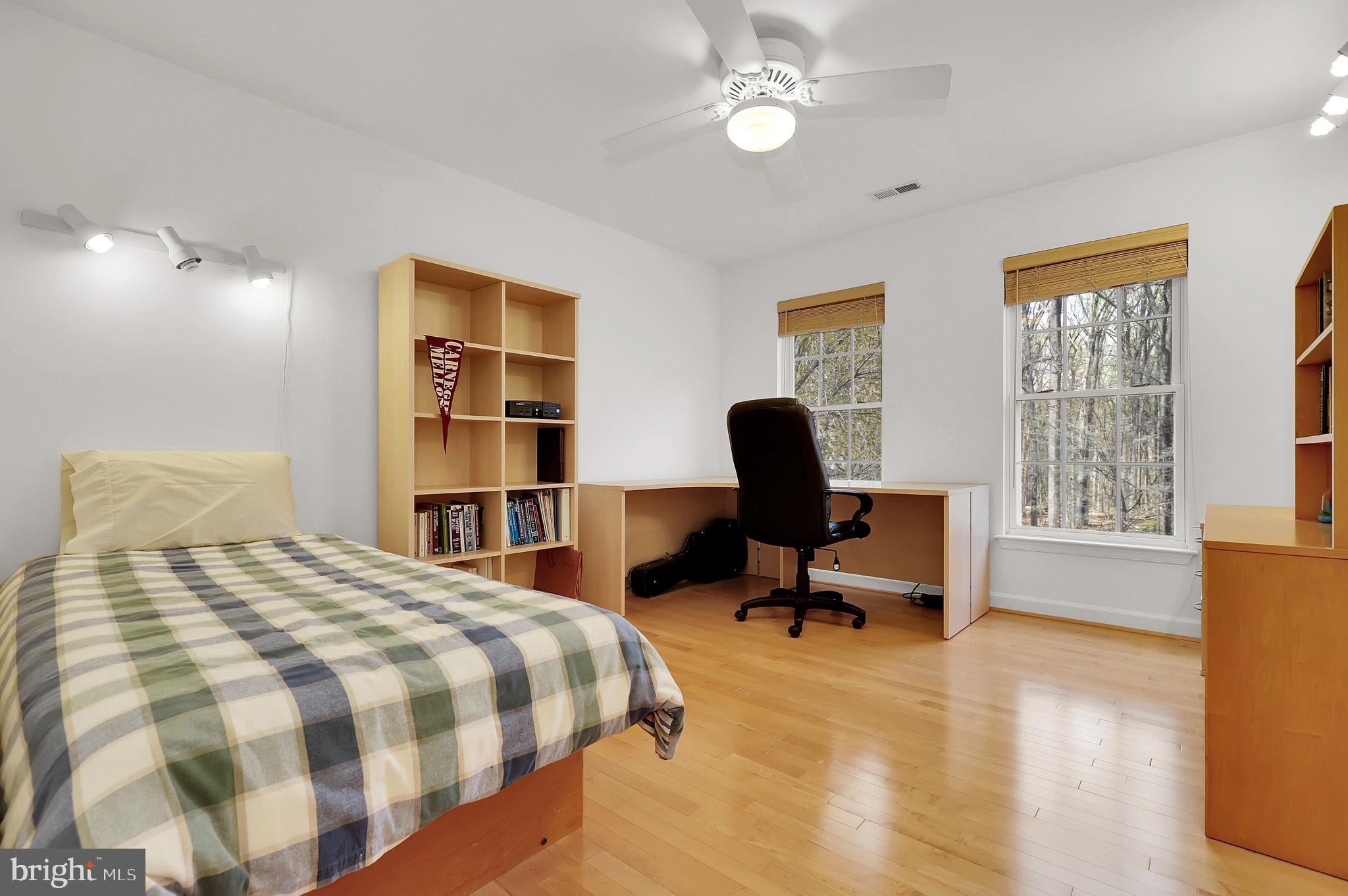 3006 Novak Terrace Burtonsville, MD 20866 - Photo 21 of 71 a bedroom with a bed a table and a bookshelf
