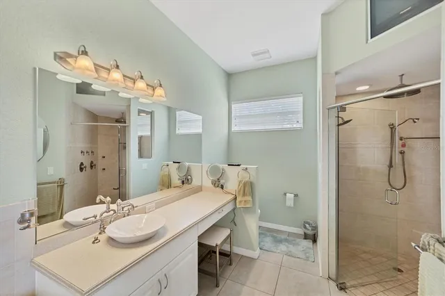 a bathroom with a sink vanity granite and shower