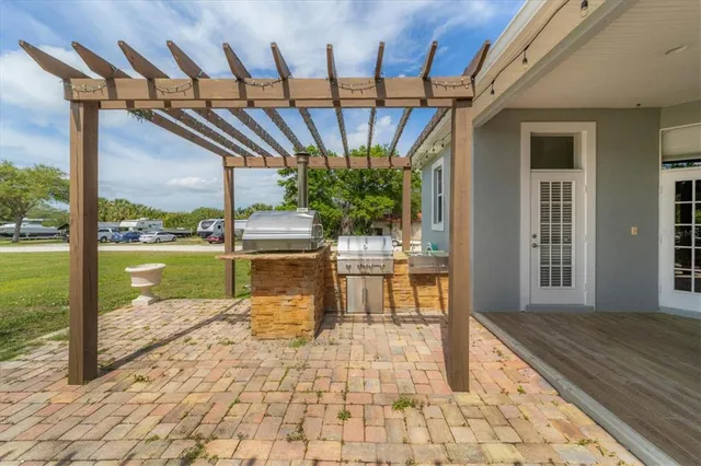 a view of swimming pool with a table and chairs in patio