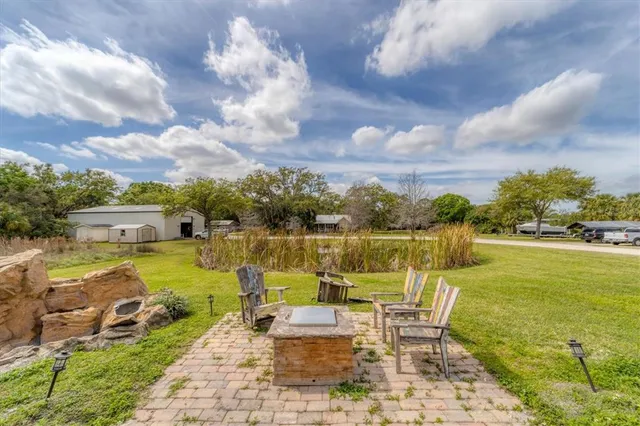 a view of a lake with couches chairs and city view