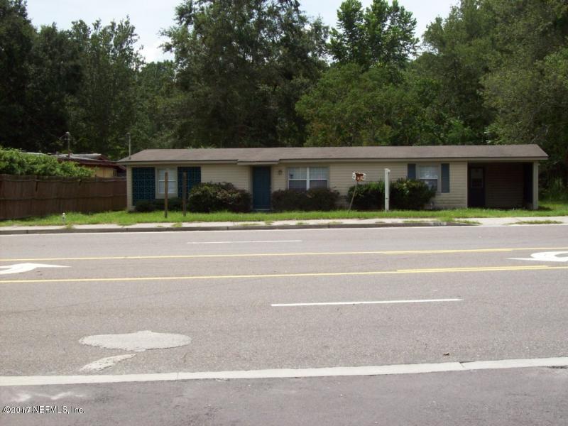 904 New Berlin Road Jacksonville, FL 32218 - Photo 11 of 19 a white house with a large windows next to a yard