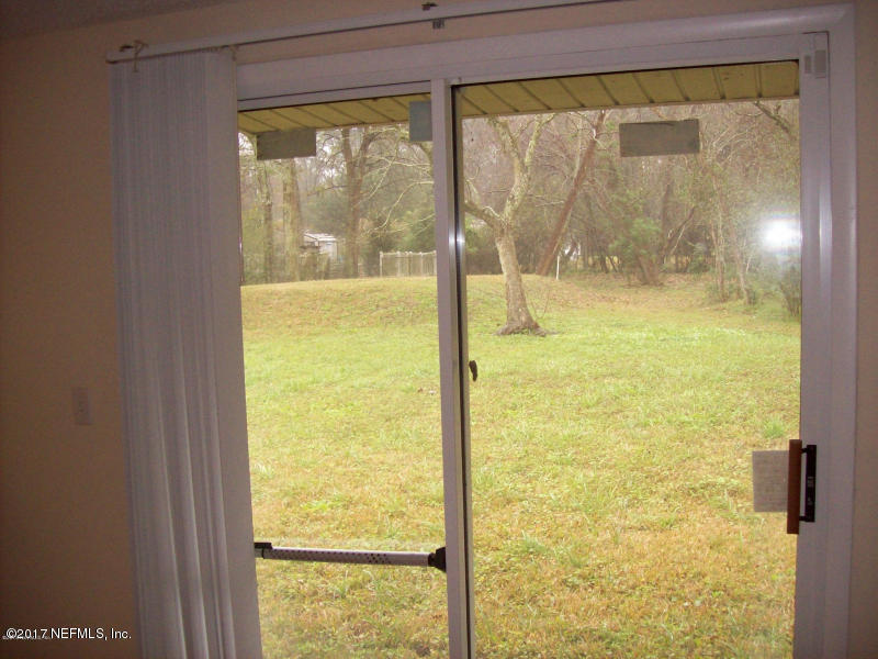 904 New Berlin Road Jacksonville, FL 32218 - Photo 7 of 19 a view of a glass door with a large window