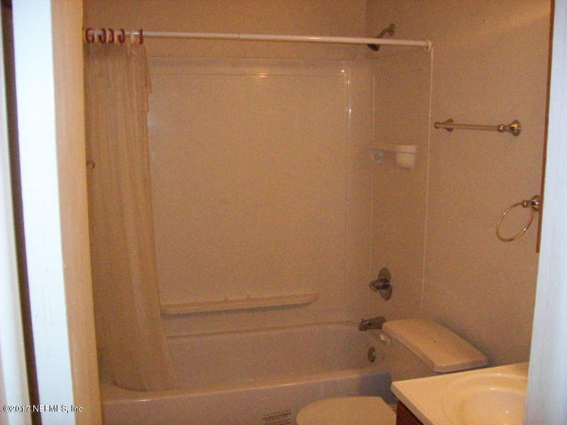 904 New Berlin Road Jacksonville, FL 32218 - Photo 10 of 19 a bathroom with a shower and toilet
