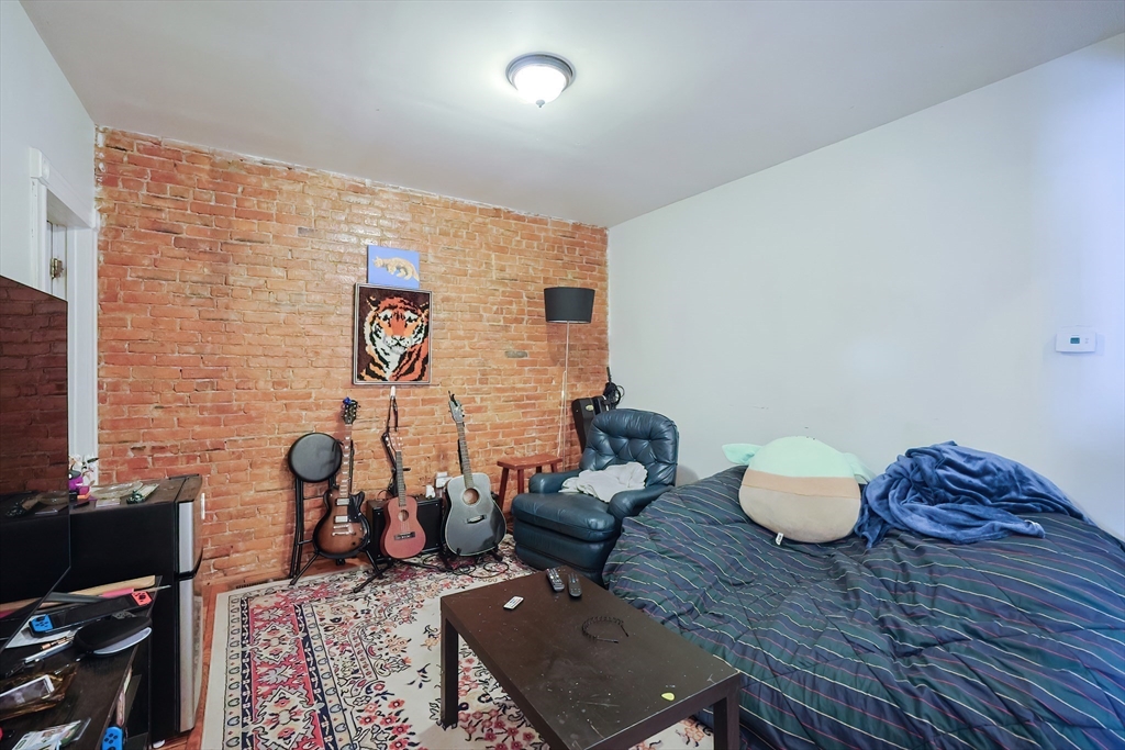 35 Adamson Street, Unit 2 Boston, MA 02134 - Photo 2 of 15 a living room with furniture and a flat screen tv