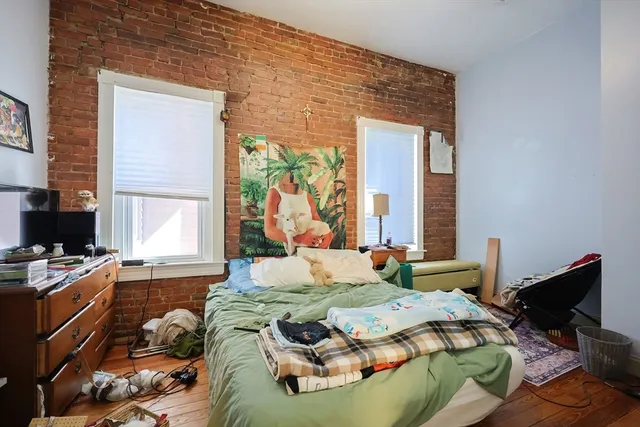 a bed sitting in a bedroom next to a window