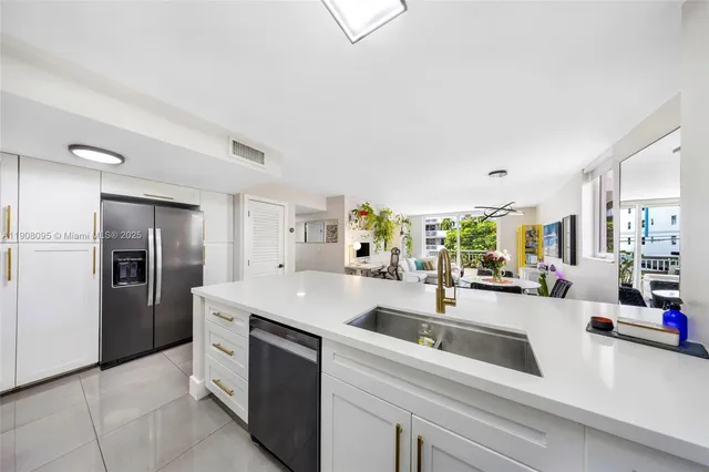 a kitchen with stainless steel appliances a sink stove and refrigerator
