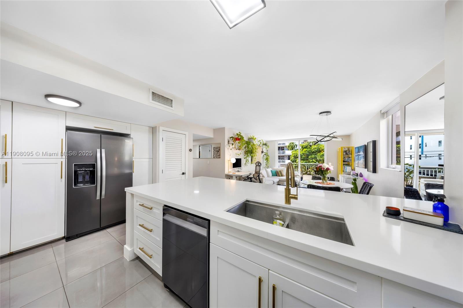 1665 Bay Road, Unit 221 Miami Beach, FL 33139 - Photo 12 of 32 a kitchen with stainless steel appliances a sink stove and refrigerator