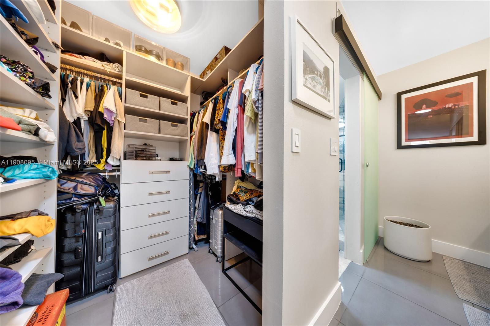 1665 Bay Road, Unit 221 Miami Beach, FL 33139 - Photo 22 of 32 a view of walk in closet with clothes and shoes