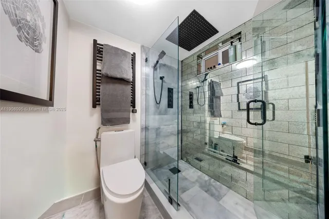 a bathroom with a toilet and a shower