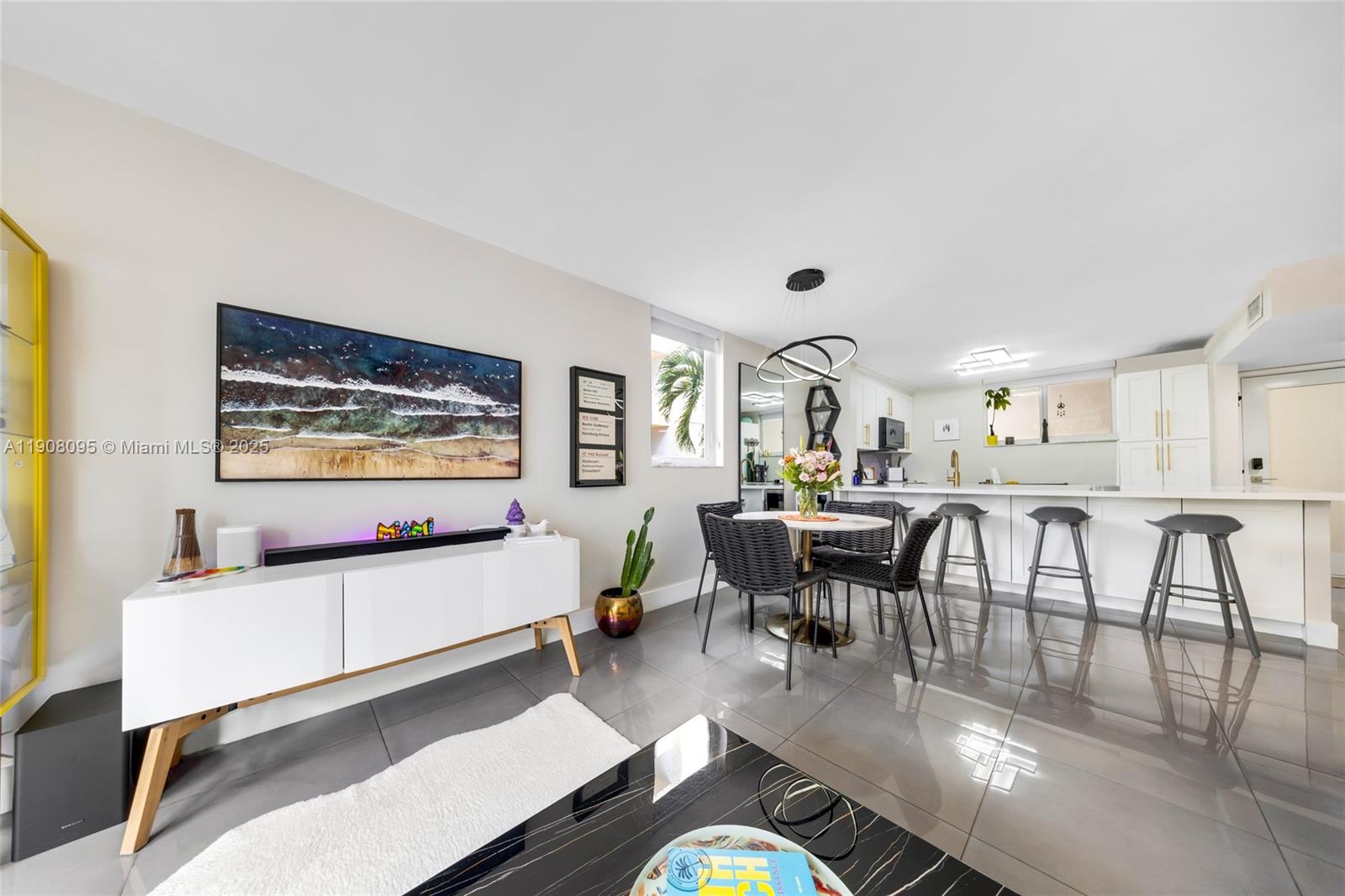 1665 Bay Road, Unit 221 Miami Beach, FL 33139 - Photo 7 of 32 a living room with furniture and a flat screen tv