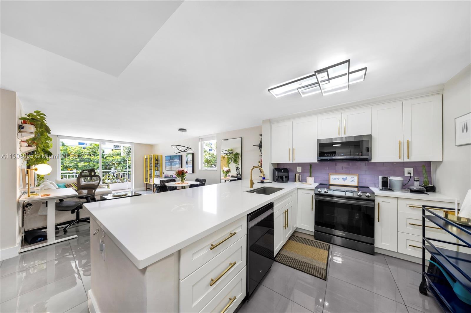 1665 Bay Road, Unit 221 Miami Beach, FL 33139 - Photo 10 of 32 a kitchen with a sink a stove top oven and cabinets