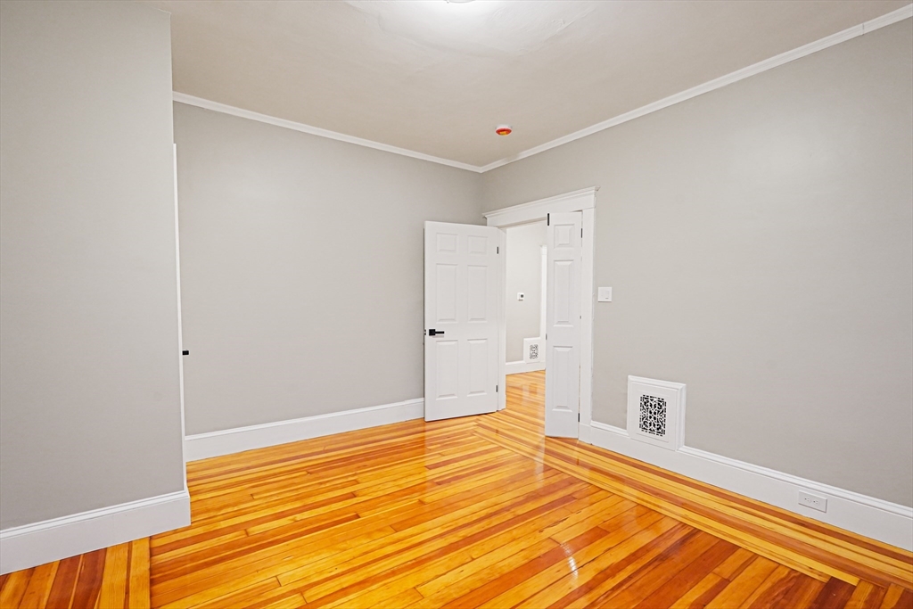 381 Adams Street, Unit 3 Boston, MA 02122 - Photo 17 of 41 a view of a room with wooden floor