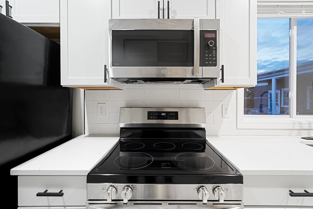 381 Adams Street, Unit 3 Boston, MA 02122 - Photo 2 of 41 a stove top oven sitting inside of a kitchen