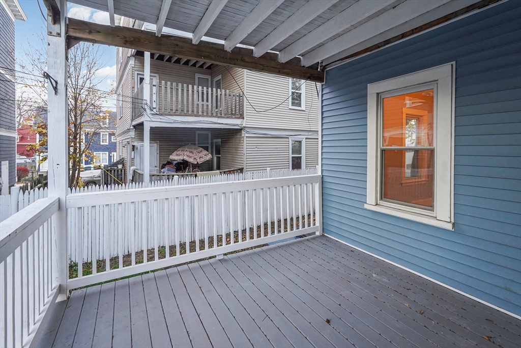 381 Adams Street, Unit 3 Boston, MA 02122 - Photo 25 of 41 a porch with wooden floor
