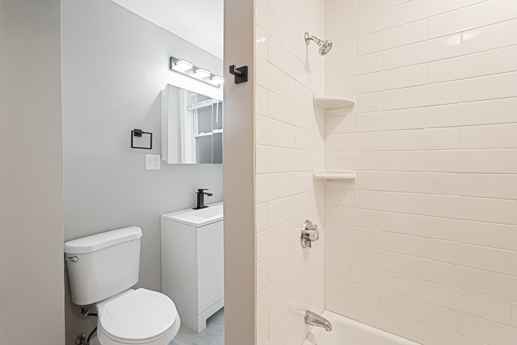 381 Adams Street, Unit 3 Boston, MA 02122 - Photo 7 of 41 a white toilet sitting next to a bathroom sink