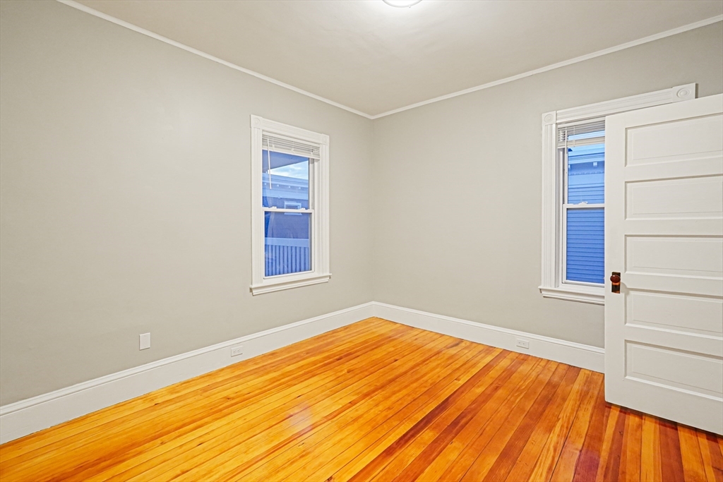 381 Adams Street, Unit 3 Boston, MA 02122 - Photo 9 of 41 a view of empty room with wooden floor and fan