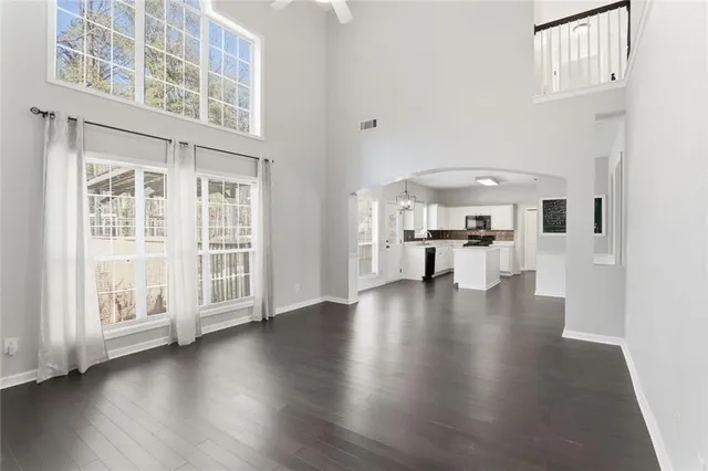 a view of a living room with a furniture wooden floor and a kitchen