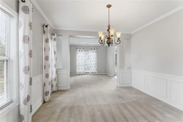 a view of a chandelier in big room and chandelier