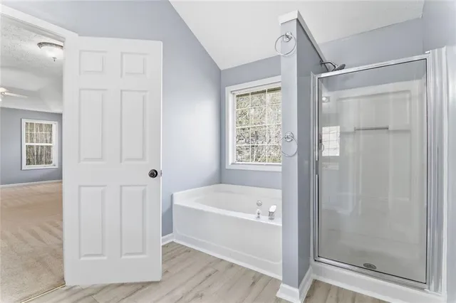 a bathroom with a bathtub and shower