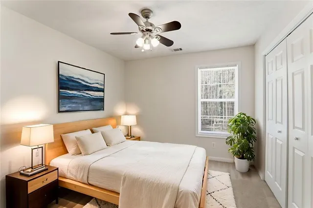a bedroom with a bed and a potted plant
