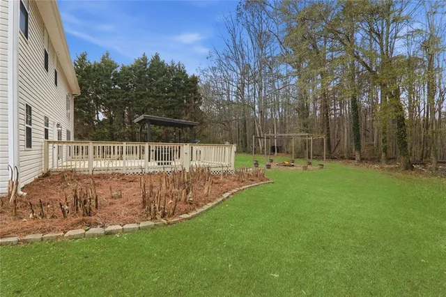 a view of backyard with trampoline