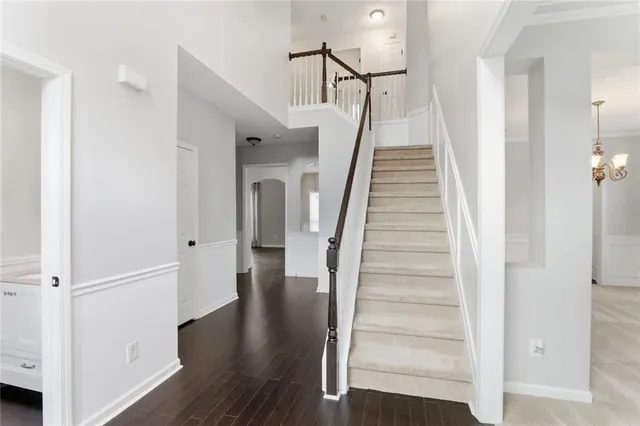 a view of a hallway with wooden floor and entryway