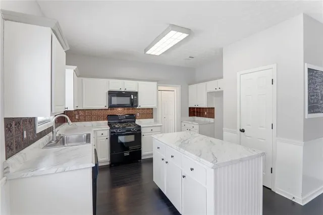 a kitchen with a sink stove and refrigerator