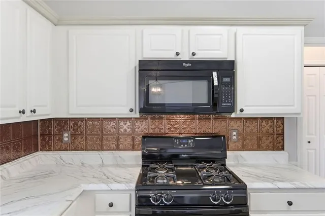 a kitchen with a stove and a microwave