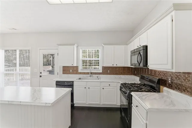 a kitchen with a sink stove and cabinets