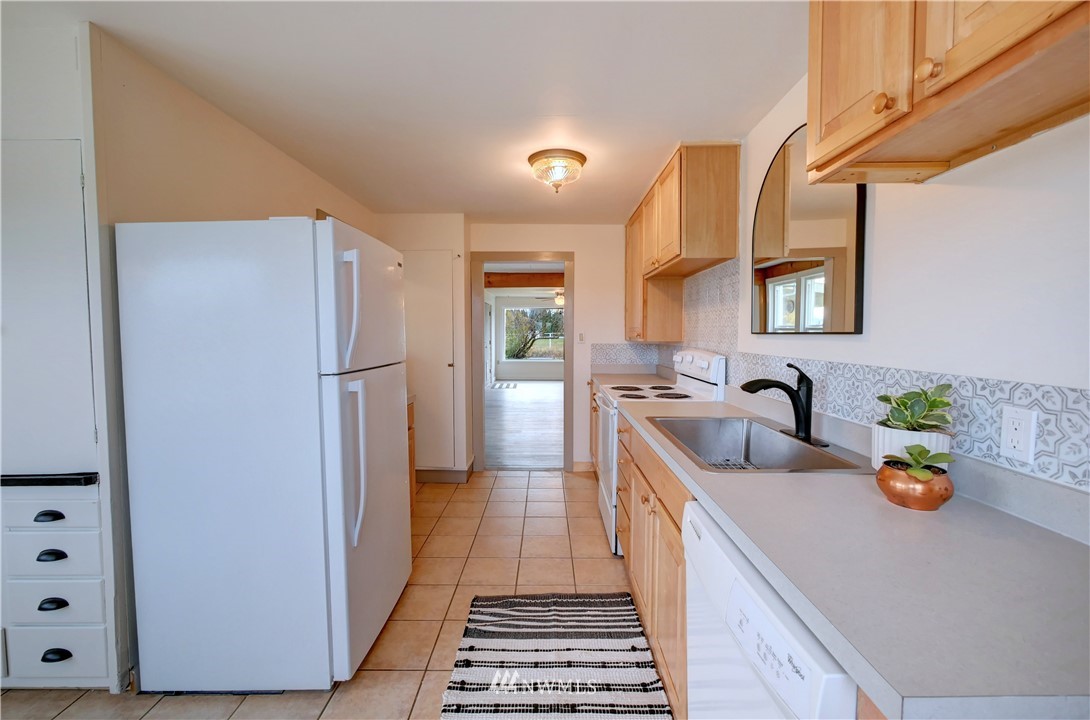 28 Fiker Road Omak, WA 98841 - Photo 13 of 39 a kitchen with stainless steel appliances a refrigerator a sink a stove and white cabinets